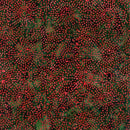 Batik fabric patterned with bursts of red dots on a green background