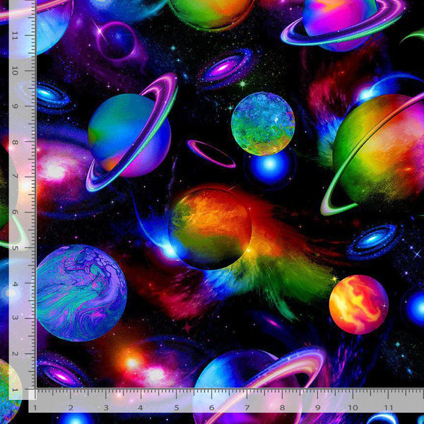 Colorful space-themed fabric with planets and stars, featuring a ruler for scale.