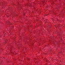 A swatch of pink batik fabric featuring swirling wavelike designs in a lighter shade of pink