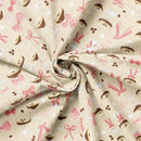 Fabric with a pattern of glasses, coffee beans, and bows on a beige background