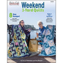 The front cover of Fabric Cafe's Weekend 3 Yard Quilt book featuring 8 new designs. On the front cover, the authors Donna Robertson and Fran Morgan sit by a lake, with sample quilts draped over their chairs. 