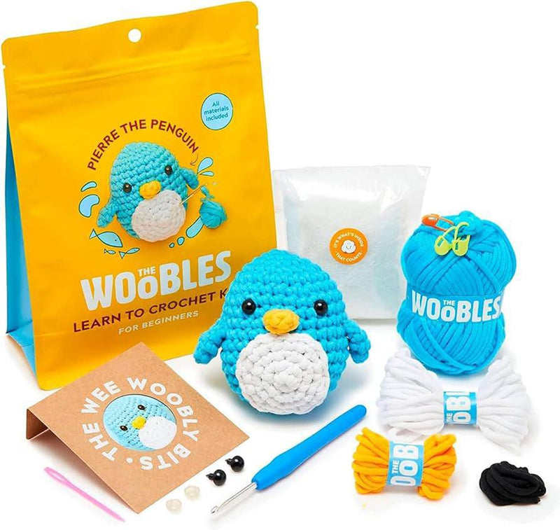 Crochet kit with a penguin-themed product, yarn, and tools
