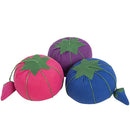 Small tomato pin cushions with strawberry emeries in assorted bright colors. 